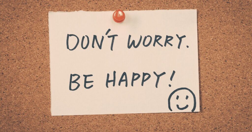 Don’t worry, be happy」と書かれたメモで、引越し挨拶を気にしすぎなくてよいことを表したイメージ